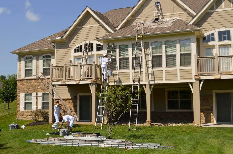 Painters painting exterior of a home